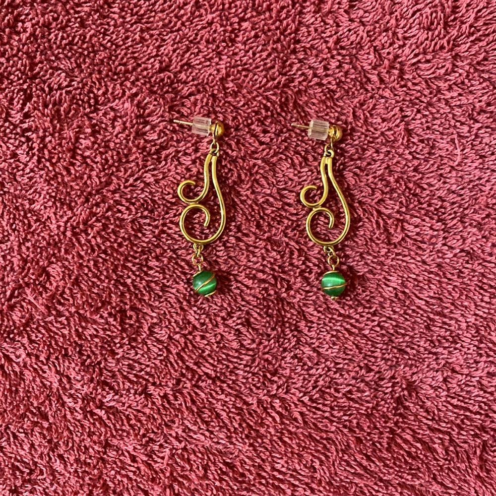 Gold-coloured earrings, with lovely green stones